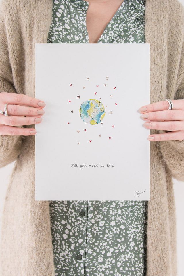 'All you need is love' art print of a world surrounded by love hearts, painted by Carla Gebhard.